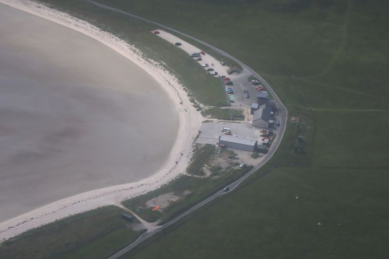 A plane landing on the tidal beach runway at Barra Airport